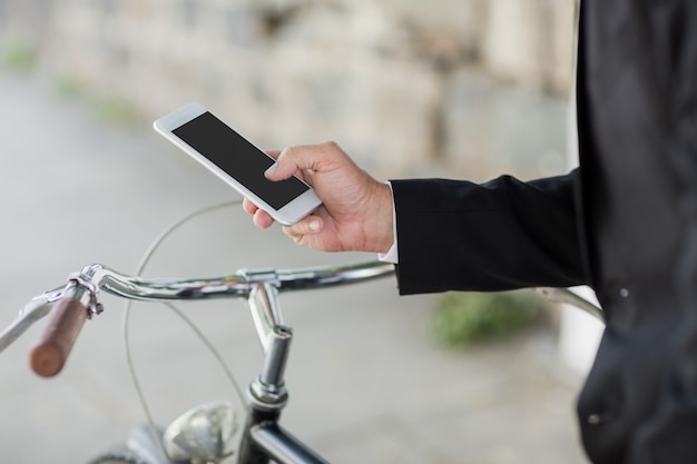 Midsection of businessman using cellphone