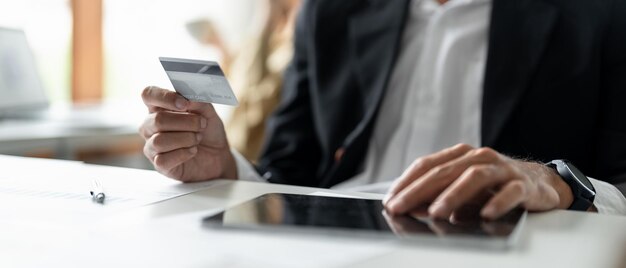 Midsection of businessman using mobile phone