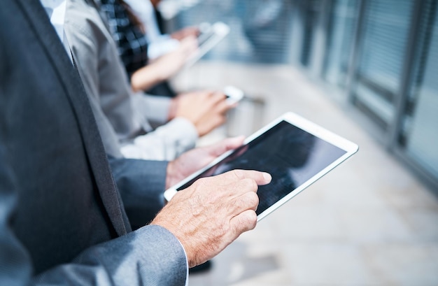 midsection of businessman using mobile phone