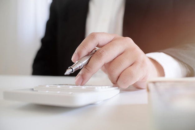 Midsection of businessman working at desk in office