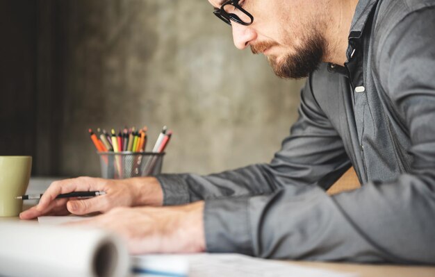 midsection of businessman working on table