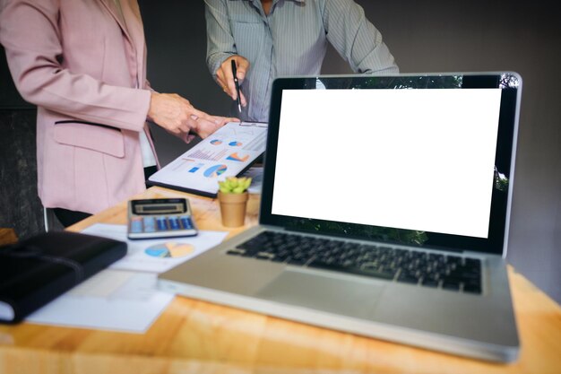 Midsection of businessmen discussing at desk in office