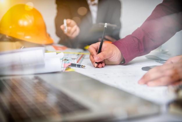 Midsection of businesswoman discussing with colleague at desk in office