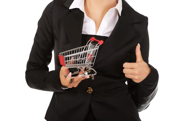 Photo midsection of businesswoman holding shopping cart against white background