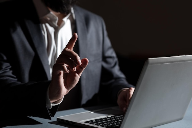 Midsection of businesswoman using laptop at office