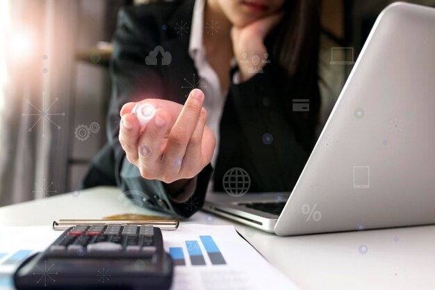 Midsection of businesswoman using laptop at office