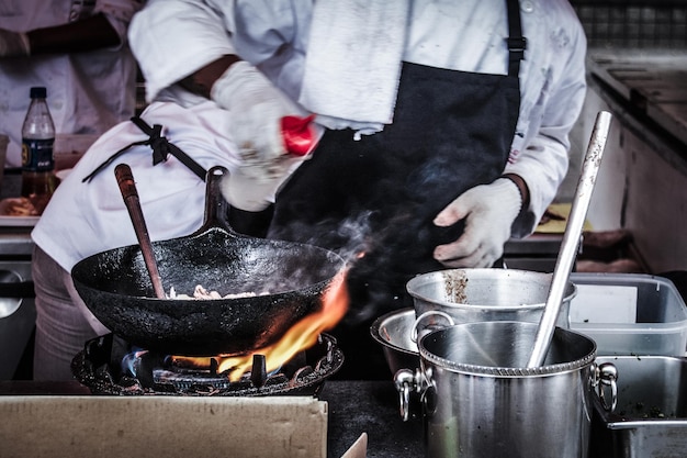 midsection of chef preparing food in kitchen
