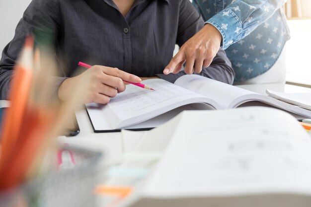 midsection of colleagues doing paperwork in office