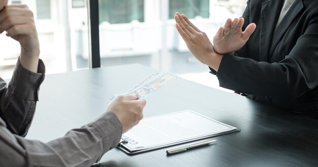 Midsection of couple holding hands on table