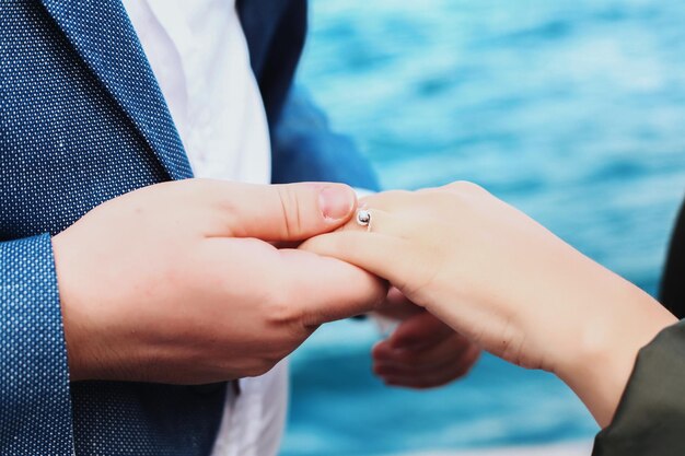 Midsection of couple holding hands