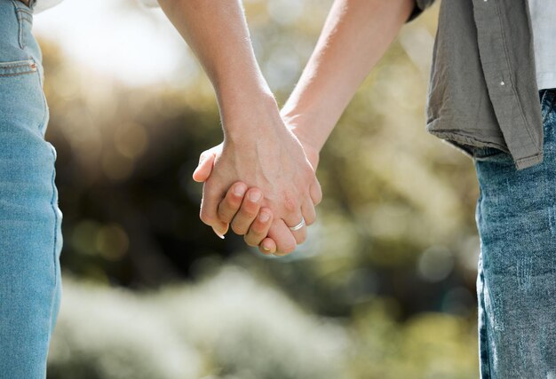 Midsection of couple holding hands