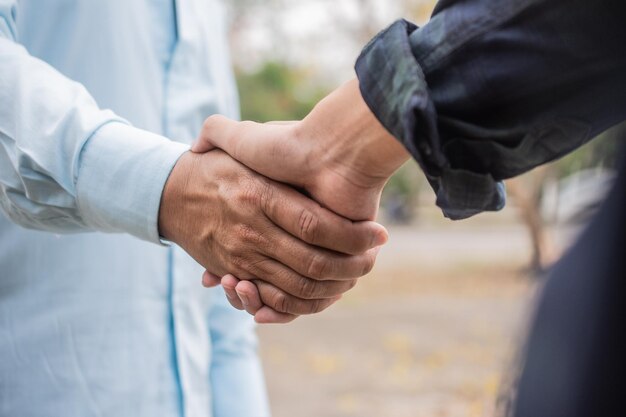 Midsection of couple holding hands