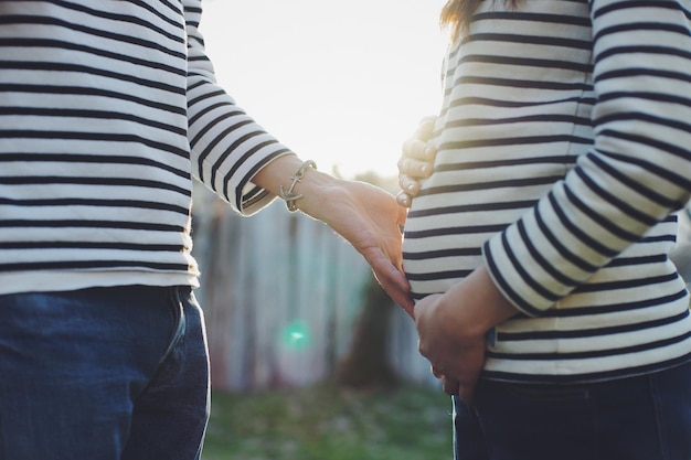 Midsection of couple standing outdoors