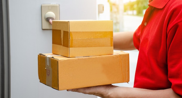 Midsection of delivery person holding packages