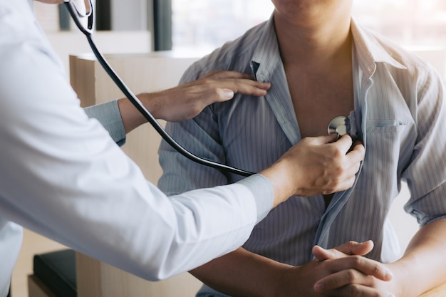 Midsection of doctor checking patient on table