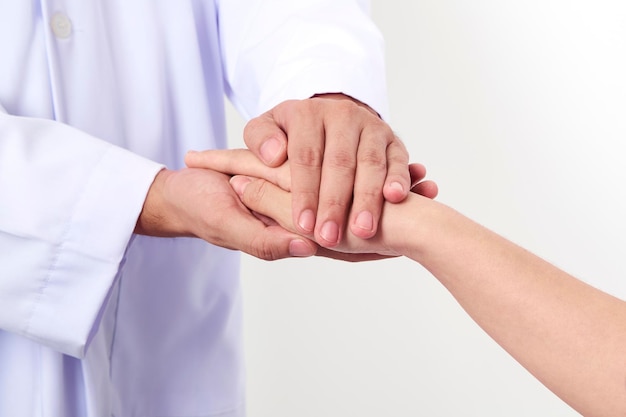 Midsection of doctor consoling woman at hospital