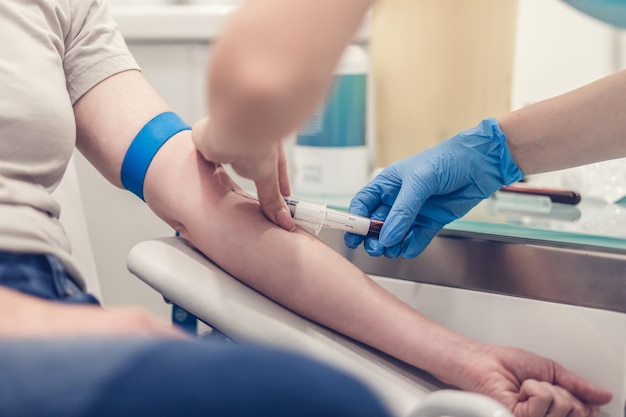 midsection of doctor examining patient at clinic