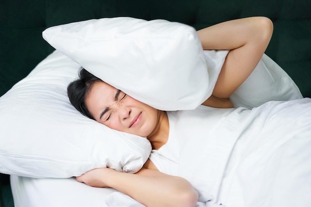 Midsection of doctor examining patient lying on bed