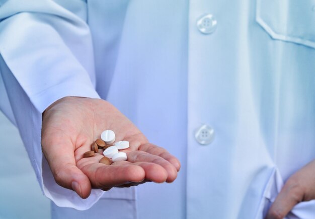 Midsection of doctor holding medicines