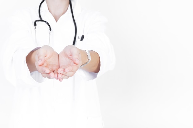 Photo midsection of doctor holding stethoscope against white background