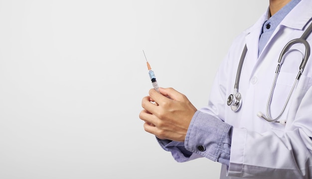 Photo midsection of doctor holding syringe against white background