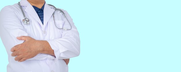 Midsection of doctor standing against blue background