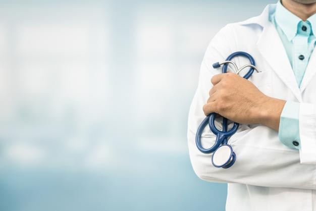 midsection of doctor standing with arms crossed