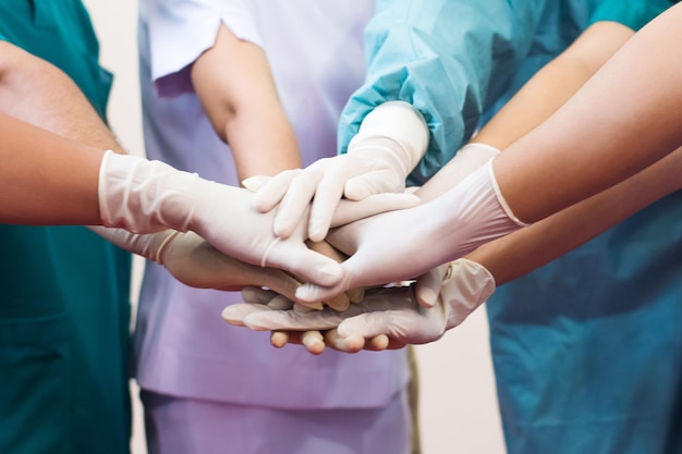Photo midsection of doctors stacking hands