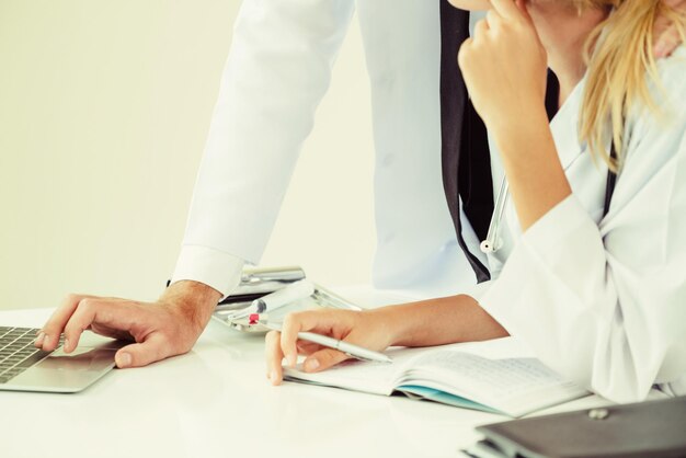 Midsection of doctors working in hospital