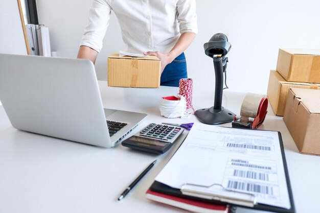 Midsection of entrepreneur using laptop in office