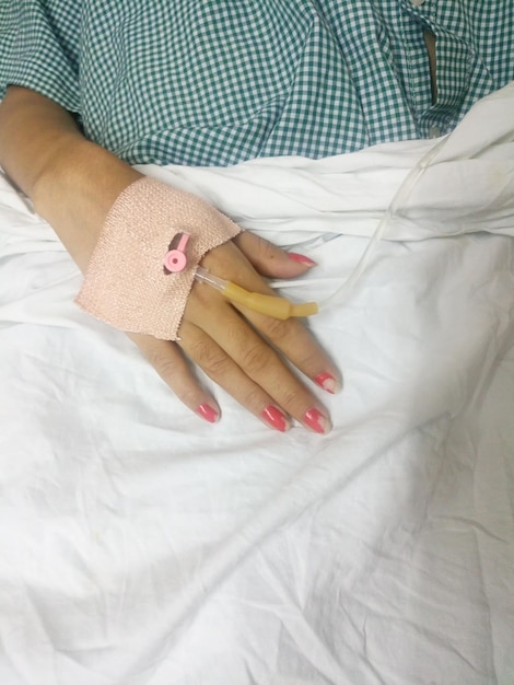 midsection of female patient with iv drip in hospital