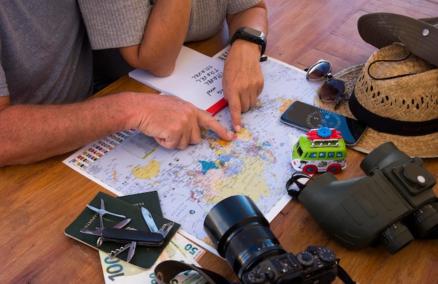 Photo midsection of friends pointing at map