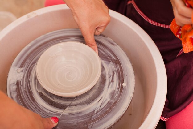 Photo midsection of girl using pottery wheel
