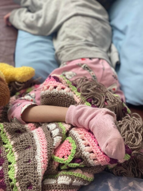 Photo midsection of girl with toy on bed