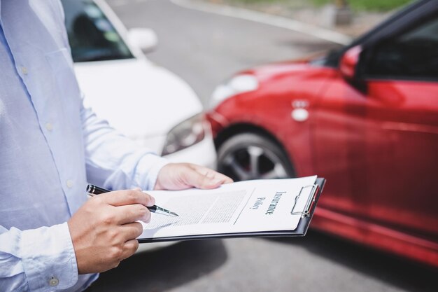 Photo midsection of insurance agent writing on paper while standing outdoors