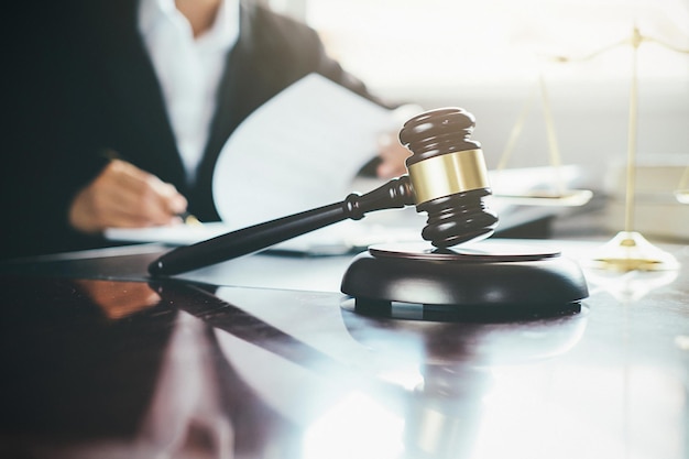midsection of lawyer working by gavel on desk