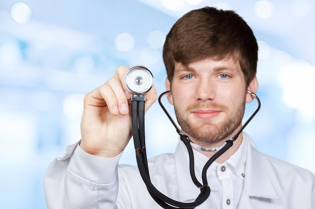 Photo midsection of male doctor holding stethoscope