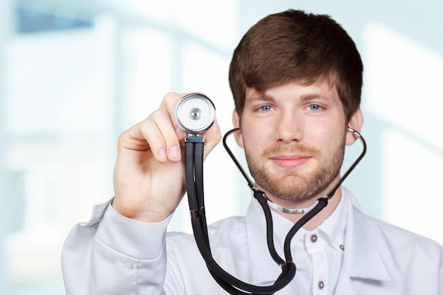 Midsection of male doctor holding stethoscope