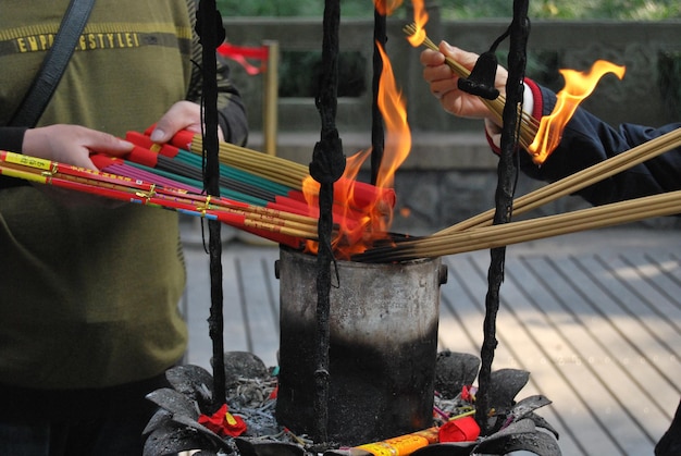 Photo midsection of man burning incenses