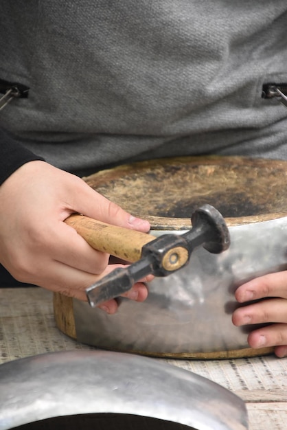 Photo midsection of man covering metallic sheet on wood