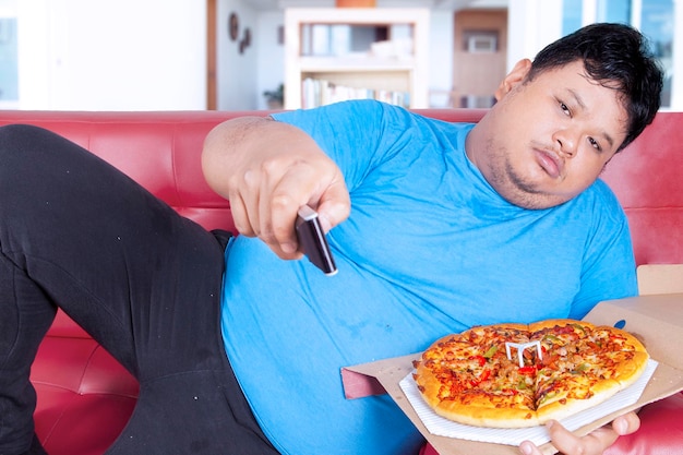 Midsection of man eating food at home