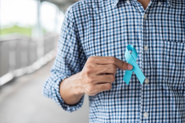 Photo midsection of man holding blue ribbon