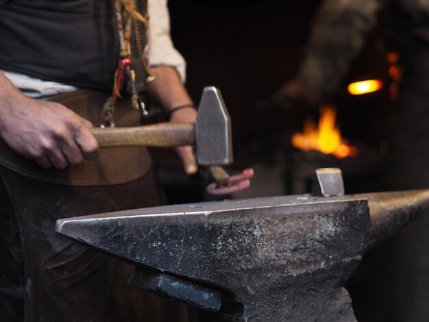 Photo midsection of man holding burning candles on metal