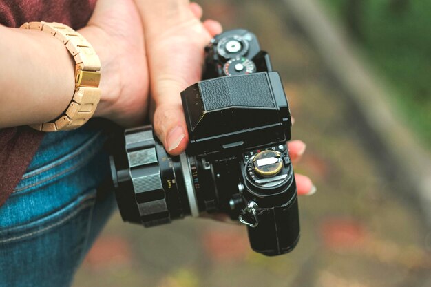 Midsection of man holding camera