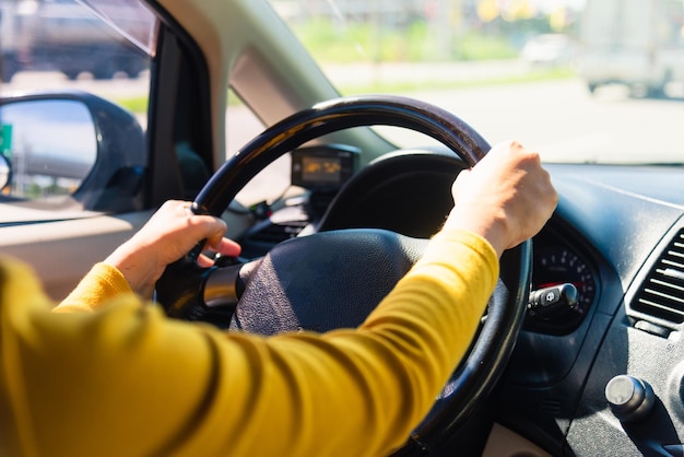 Midsection of man holding cigarette on car