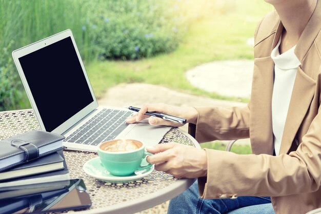 Midsection of man holding coffee cup on table