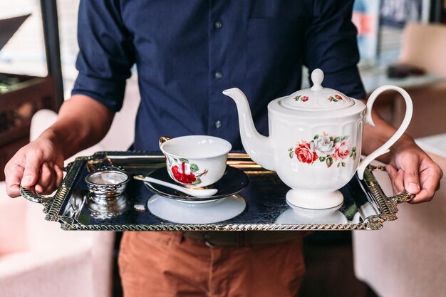 Midsection of man holding coffee cup