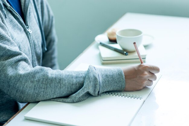 Midsection of man holding coffee cup