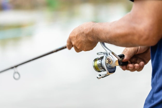 Photo midsection of man holding fishing rod