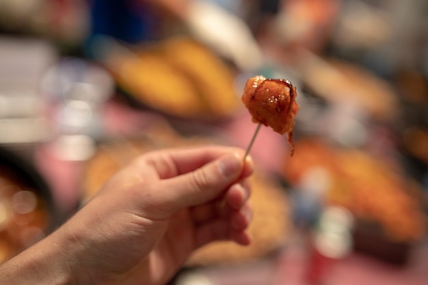 midsection of man holding food at market stall